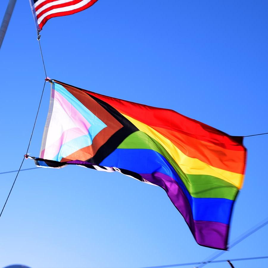 Pride flag with corner USA flag shows in back.